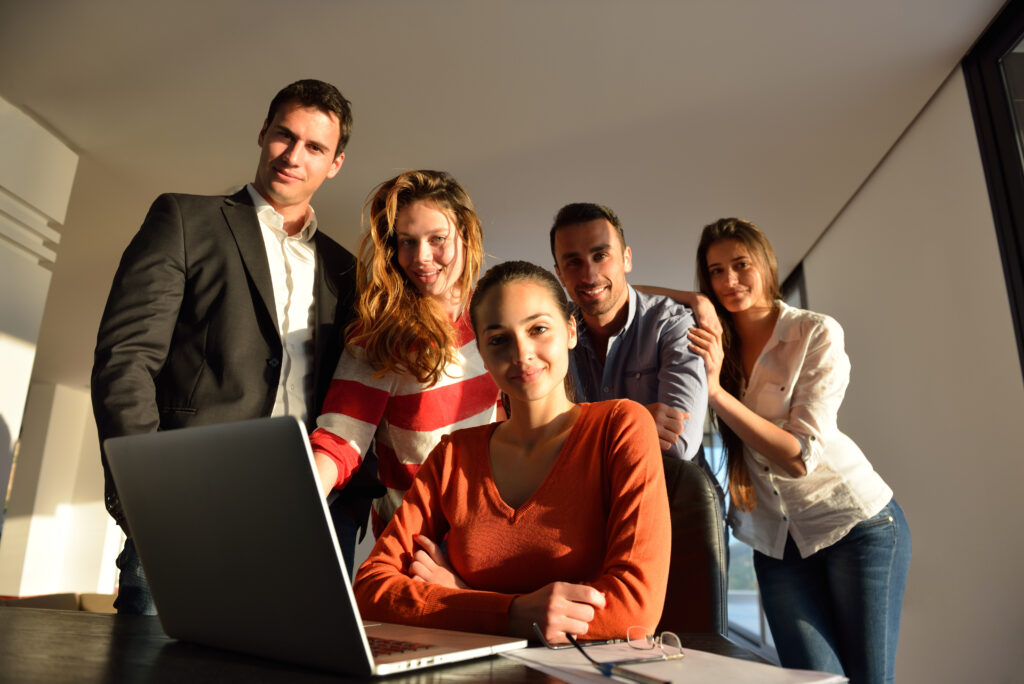 Business people looking at laptop with ROI from Social Media Strategy