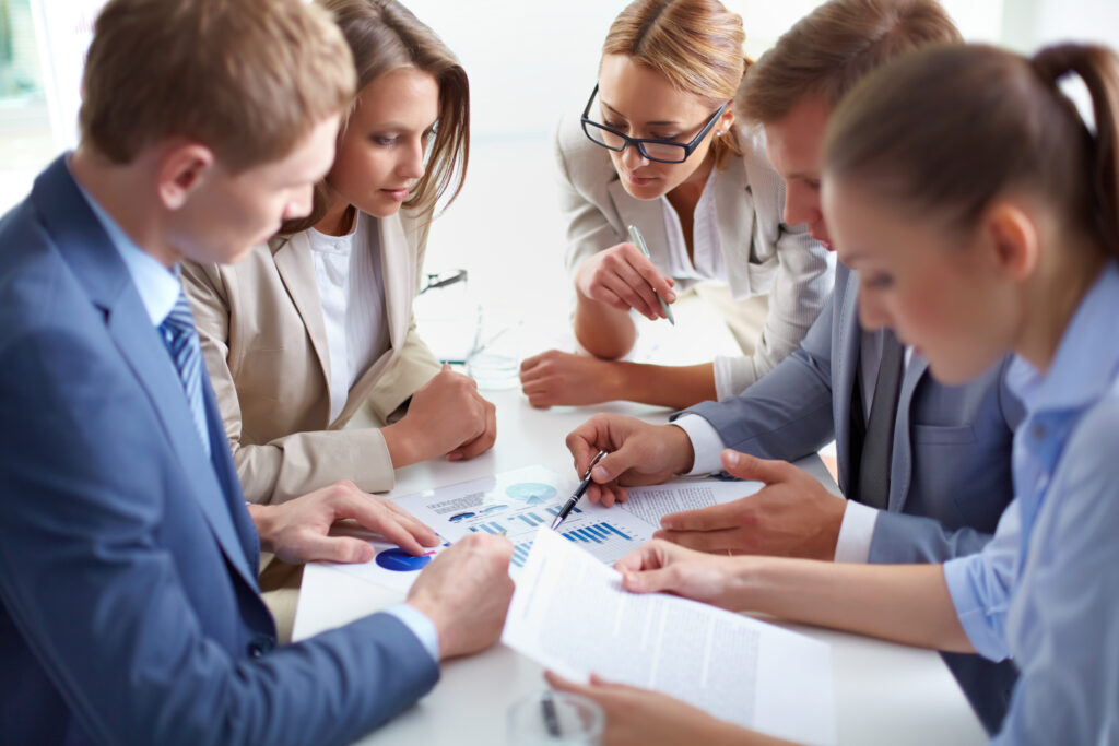 Image of business partners discussing success of social media campaign at meeting